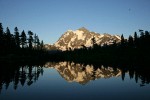Mt. Shuksan reflected in Picture Lake near sunset w/ Mountain Hemlock silhouettes